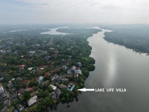 an aerial view of a river with a white arrow at Lake Life Villa in Ambalangoda