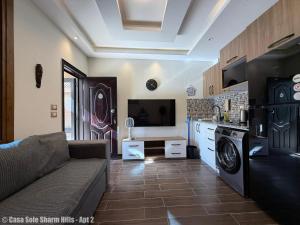 a living room with a couch and a kitchen at Casa Sole Sharm Hills Apt 2 in Sharm El Sheikh