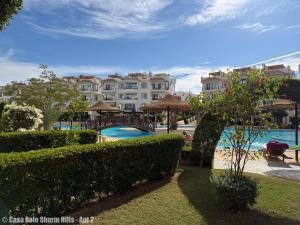 a view of a resort with a pool and a building at Casa Sole Sharm Hills Apt 2 in Sharm El Sheikh