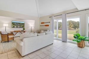 a living room with a white couch and a table at Spinnaker 753 in Seabrook Island