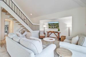 a living room with two white couches and a staircase at Spinnaker 753 in Seabrook Island