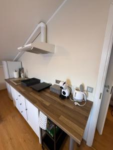 a kitchen with a wooden counter top in a room at Perlos Apartamentai 12 in Birštonas