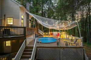 a screened in porch with a pool on a house at Pocono nirvana in East Stroudsburg