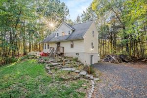 a white house in the middle of the forest at Pocono nirvana in East Stroudsburg