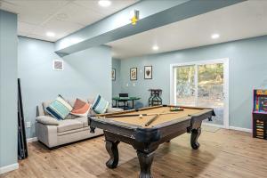 a living room with a pool table and a couch at Pocono nirvana in East Stroudsburg