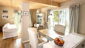 a dining room with a table and chairs and a desk at Am Inselufer in Werder