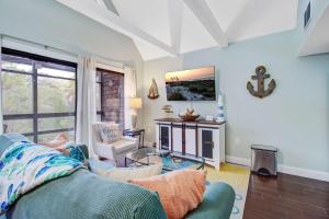 a living room with a blue couch and a fireplace at Mariner's Watch 4267 in Kiawah Island +16 photos