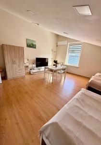 a living room with a table and a dining room at Perlos Apartamentai 12 in Birštonas