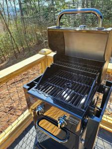 a grill sitting on top of a porch at Tiny Home Big View! in Franklin