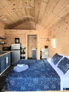 a bedroom with a large bed in a cabin at Tiny Home Big View! in Franklin