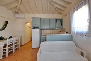 a kitchen with a bed and a table in a room at Anatoli Villa in Steni Vala Alonissos