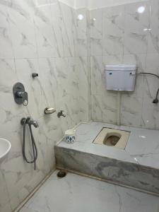 a bathroom with a shower and a toilet in it at Pappu niwas in Siliguri
