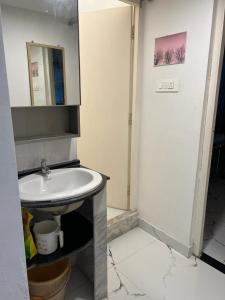 a bathroom with a sink and a mirror at Pappu niwas in Siliguri +2 photos