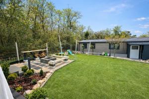 a yard with a playground and a house at Cute Cottage in Balatonfůzfő