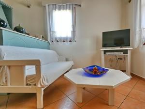 a room with a bed and a table and a tv at Anatoli Villa in Steni Vala Alonissos