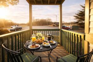 a breakfast table on a porch with a view of a parking lot at Beech Mountain Studio - Trails, Concerts & Bike Park in Beech Mountain