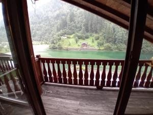 a view of a lake from a window of a cabin at Il quattordici in Rimasco +3 photos