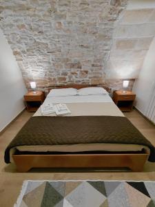 a bedroom with a large bed with two night stands at Le Stanze sul Colle in Palo del Colle