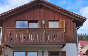 a wooden house with a balcony on top of it at Donaublick Möhringen in Tuttlingen
