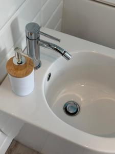 a white sink with a faucet on top of it at B&B Greenmind in San Dorligo della Valle