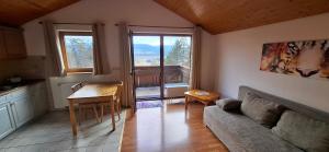 a living room with a couch and a table at Donaublick Möhringen in Tuttlingen
