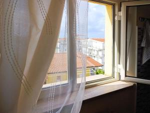 a window with a view of a city at Casa Bonifacio in Scalea