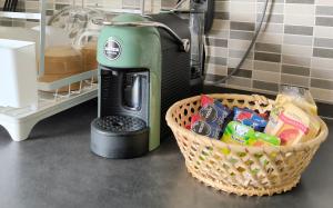 a coffee machine sitting next to a basket of food at Casa Bonifacio in Scalea