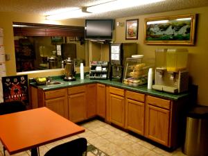 a restaurant kitchen with a counter top with a food at HWY Express Inn & Suites in Stillwater