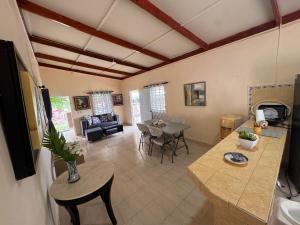a living room with a table and a dining room at Casa de campo El Bonao in Higuey