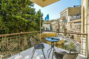 a balcony with chairs and a table on a balcony at Art Club in Baku