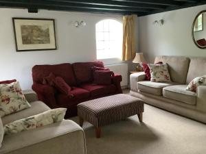 a living room with couches and chairs and a window at Bellows Mill in Dunstable +7 photos