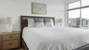 a bedroom with a white bed and a window at Landing Modern 2BD Gym Clubhouse in Longmont +43 photos