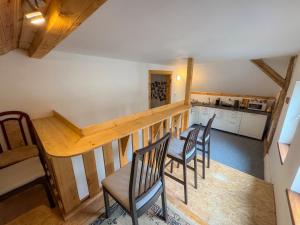 a kitchen and dining room with a table and chairs at Krušnohorský Poutník in Kovářská