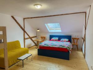 a bedroom with a bed and a couch at Krušnohorský Poutník in Kovářská