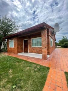 a small brick house with a brick driveway at Casita de Natalia in San Bernardino