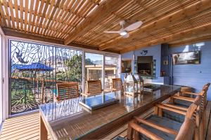 a room with a table and chairs and a window at The Mermaid's Tail in Pringle Bay