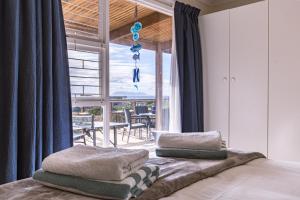 a bedroom with a bed with two pillows on it at The Mermaid's Tail in Pringle Bay +38 photos