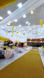 a large banquet hall with white tables and yellow balloons at Feliza Hotel and Suites in Abeokuta