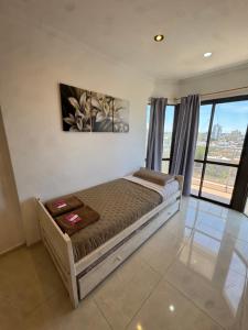 a bedroom with a bed and a large window at Panoramico in Santa Teresita +9 photos