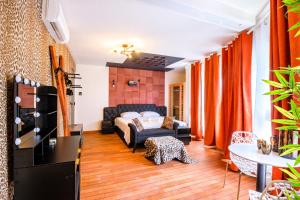 a living room with a bed and a couch at Cristalys Loveroom & Spa in Montpellier +5 photos