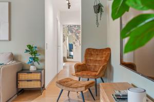 a living room with two chairs and a table at dreamfactory Residences - Wine Escapes # 3BR Suite in Langenlois