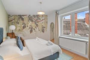 a bedroom with two beds and a window at dreamfactory Residences - Wine Escapes # 3BR Suite in Langenlois