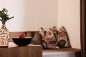 a bowl of fruit on a table next to a couch at Hotel Geisler Tulfes in Tulfes