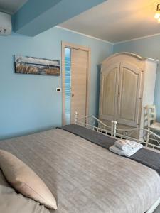 a bedroom with a large bed and a cabinet at B&B Greenmind in San Dorligo della Valle