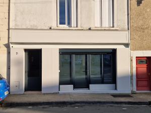 a building with two doors on the side of it at La Suite Mirebalaise in Poitiers