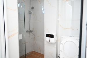 a bathroom with a shower and a toilet at Vila Bashkim in Ksamil +153 photos