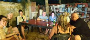 a group of people are sitting around a table at Adam's Heaven in Alleppey