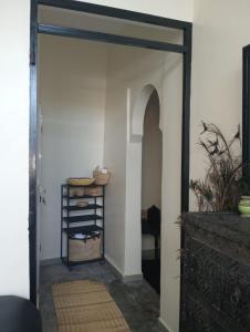 an open door leading into a room with a table at Dar Tissila in Marrakesh