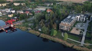 an aerial view of a building next to a river at Kapitańska Przystań - basen & sauna & jacuzzi & klimatyzacja & garaż in Dziwnów
