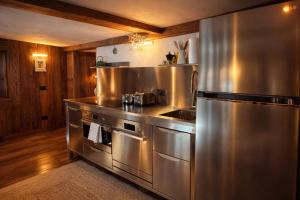 a large kitchen with stainless steel appliances at Casalpina Cozy chalet in Gressoney-la-Trinité